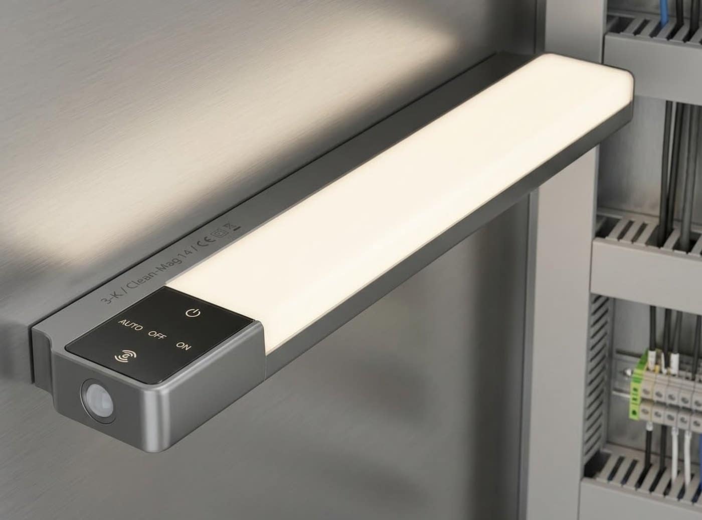 LED-Schaltschrankleuchte mit Magnetbefestigung an der Stahlwand eines Schaltschranks, im Hintergrund Reihenklemmen